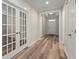 Hallway featuring hardwood floors, white trim, and a welcoming entrance at 4996 Song Sparrow Way, Summerville, SC 29483