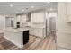 Bright kitchen with white cabinets, an island, stainless appliances, and a walk-in pantry at 4996 Song Sparrow Way, Summerville, SC 29483