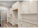 Well-lit kitchen with granite counters, white cabinets and backsplash at 4996 Song Sparrow Way, Summerville, SC 29483