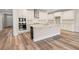 The island kitchen has white cabinets, granite countertops, stainless appliances at 4996 Song Sparrow Way, Summerville, SC 29483