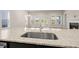 Granite countertop on kitchen island features a stainless steel sink and modern faucet at 4996 Song Sparrow Way, Summerville, SC 29483