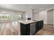Open floor plan with a kitchen island, stainless steel dishwasher, and a view of the living area at 4996 Song Sparrow Way, Summerville, SC 29483