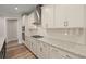 Modern kitchen with white cabinets, granite countertops, and stainless steel appliances at 4996 Song Sparrow Way, Summerville, SC 29483