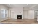 Bright living room with hardwood floors, fireplace, and views from the large window at 4996 Song Sparrow Way, Summerville, SC 29483