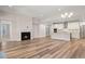 Spacious living room with hardwood floors, a fireplace, and an open connection to the kitchen at 4996 Song Sparrow Way, Summerville, SC 29483
