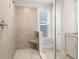 Modern shower with neutral tile, glass door, and convenient built-in seat at 4996 Song Sparrow Way, Summerville, SC 29483
