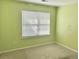 Bright and airy bedroom features a large window that offers plenty of natural light and soft carpeted floor at 5226 Fernland Way, North Charleston, SC 29420
