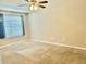 Cozy bedroom features a ceiling fan, plush carpeting, and window that offer natural light at 5226 Fernland Way, North Charleston, SC 29420