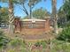 Welcoming brick entrance to Coosaw Commons, framed by palm trees and lush landscaping at 5226 Fernland Way, North Charleston, SC 29420