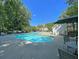 Community pool with tables and lounge seating, perfect for relaxation on a sunny day at 5226 Fernland Way, North Charleston, SC 29420