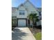 Beautiful home featuring a one-car garage, brick accents, and a well-manicured lawn with a mature palm tree at 5226 Fernland Way, North Charleston, SC 29420