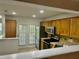 Kitchen featuring stainless steel appliances, wood cabinets, tile floors, and a breakfast bar open to the living room at 5226 Fernland Way, North Charleston, SC 29420
