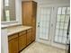 Bright kitchen with cabinets and stainless steel appliances and a door with bright light shining through at 5226 Fernland Way, North Charleston, SC 29420