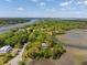 Stunning aerial perspective of a home surrounded by lush vegetation and winding waterways, offering scenic privacy at 5569 Frisco Ln, Johns Island, SC 29455