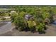 Aerial shot of a gray home surrounded by lush greenery, situated on a serene waterfront property at 5569 Frisco Ln, Johns Island, SC 29455
