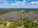 Panoramic aerial shot of waterfront homes surrounded by marshlands, showcasing a serene and natural setting at 5569 Frisco Ln, Johns Island, SC 29455