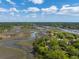 Beautiful aerial view of a home nestled amidst lush greenery and picturesque waterways, providing scenic beauty at 5569 Frisco Ln, Johns Island, SC 29455