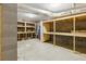 Unfinished basement with cinder block walls, concrete floor, and open storage shelving at 5569 Frisco Ln, Johns Island, SC 29455