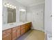 Bright bathroom featuring a double sink vanity, soaking tub and a separate glass-enclosed shower at 5569 Frisco Ln, Johns Island, SC 29455