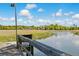 Dock view with house in background surrounded by trees and marsh at 5569 Frisco Ln, Johns Island, SC 29455