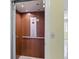 Residential elevator with wood-paneled interior and user-friendly controls for easy access between floors at 5569 Frisco Ln, Johns Island, SC 29455