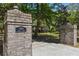 Elegant brick entrance pillars with '5569 Frisco Lane' sign, leading to a home amidst lush greenery at 5569 Frisco Ln, Johns Island, SC 29455
