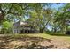 Charming two-story home with a full front porch surrounded by mature trees at 5569 Frisco Ln, Johns Island, SC 29455