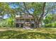Charming home with a welcoming front porch and well-manicured lawn, nestled under the shade of mature trees at 5569 Frisco Ln, Johns Island, SC 29455