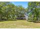 Estate Home with mature oak trees, lush landscape, and large front lawn at 5569 Frisco Ln, Johns Island, SC 29455