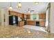 Well-lit kitchen featuring stainless steel appliances, granite countertops, and wood cabinetry at 5569 Frisco Ln, Johns Island, SC 29455