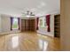 A spacious living room boasts hardwood floors, built-in bookshelves, and natural light from three windows at 5569 Frisco Ln, Johns Island, SC 29455