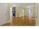 Spacious living area with hardwood floors, a stone fireplace, and ample natural light streaming through doorways at 5569 Frisco Ln, Johns Island, SC 29455