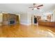 Bright and spacious living room with hardwood floors, stone fireplace, and views into the kitchen at 5569 Frisco Ln, Johns Island, SC 29455