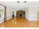 Bright living room featuring hardwood floors and stone fireplace with built-in shelving at 5569 Frisco Ln, Johns Island, SC 29455