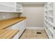 Walk-in pantry with white shelving, storage space, laminate countertops and tile flooring at 5569 Frisco Ln, Johns Island, SC 29455