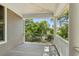 Covered outdoor porch with white support columns overlooking the green foliage at 5569 Frisco Ln, Johns Island, SC 29455