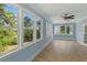 Bright sun room featuring a ceiling fan, tan tiled floors and multiple windows offering abundant natural light at 5569 Frisco Ln, Johns Island, SC 29455