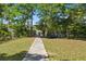 Scenic walkway leading towards the waterfront, promising serene views and tranquil access to the water at 5569 Frisco Ln, Johns Island, SC 29455