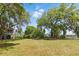 Expansive landscaped yard with mature trees and lush green lawn at 5569 Frisco Ln, Johns Island, SC 29455