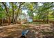 The expansive backyard features mature trees that provide plenty of shade and a wooden deck, creating an outdoor oasis at 595 Crowned Kinglet Retreat, Charleston, SC 29412