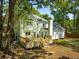 An expansive backyard features a wooden deck, lush lawn and mature shade trees, offering a private outdoor space at 595 Crowned Kinglet Retreat, Charleston, SC 29412