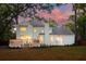The expansive backyard has a large deck, perfect for gatherings, and is bathed in the warm glow of sunset at 595 Crowned Kinglet Retreat, Charleston, SC 29412