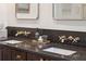 Bathroom featuring a double sink vanity with dark countertops and bronze fixtures at 595 Crowned Kinglet Retreat, Charleston, SC 29412