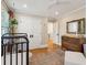 Bedroom room featuring hardwood floors, a crib, and a dresser at 595 Crowned Kinglet Retreat, Charleston, SC 29412