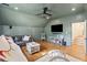 Bonus room with hardwood floors, a leather couch, a flat screen television, and a play area at 595 Crowned Kinglet Retreat, Charleston, SC 29412