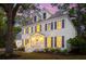 Beautiful home with warm interior lights glowing from every window at dusk at 595 Crowned Kinglet Retreat, Charleston, SC 29412