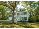 Charming two-story home with a well-manicured lawn, dormer windows and mature trees at 595 Crowned Kinglet Retreat, Charleston, SC 29412
