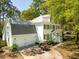 The home's exterior features a well-manicured lawn, a two-car garage, and a golf cart in the driveway at 595 Crowned Kinglet Retreat, Charleston, SC 29412