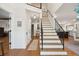 Grand foyer featuring a staircase, hardwood floors, and abundant natural light at 595 Crowned Kinglet Retreat, Charleston, SC 29412