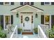 Inviting front porch with charming details, fresh wreath, and welcoming atmosphere at 595 Crowned Kinglet Retreat, Charleston, SC 29412
